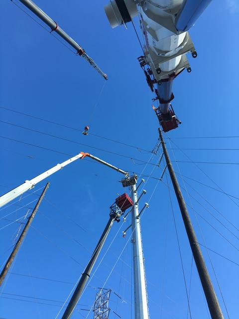 Cranes Accessing Utility Poles